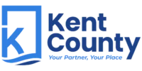 Kent County logo featuring a stylized letter "K" in a box with a wave, and the text "Kent County, Your Partner, Your Place" in blue.