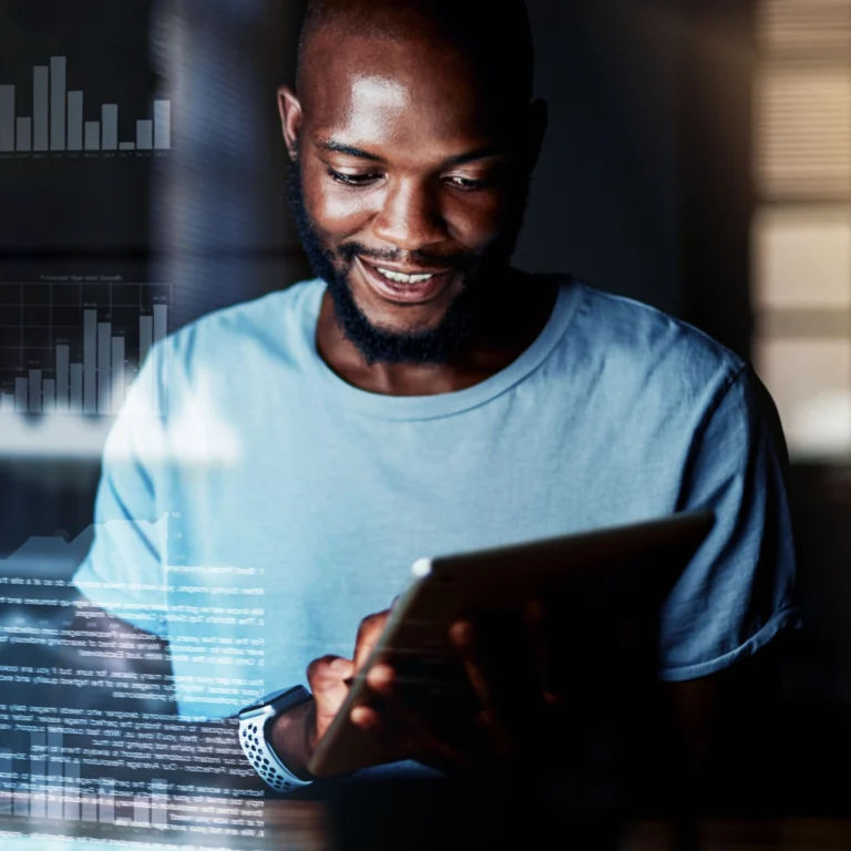 A man in a light blue shirt uses a tablet, with graphs and data visualizations superimposed in the foreground.