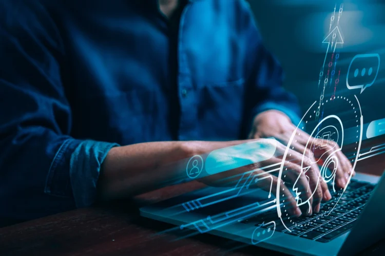 Person typing on a laptop with blue digital graphics and icons overlaid, representing technology and online communication.