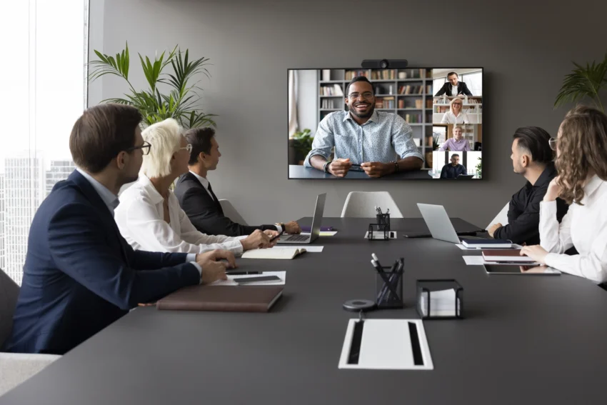 Group of professionals at conference table on video call