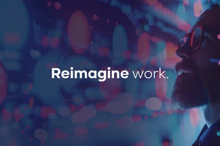 A person with a beard and sunglasses looks at digital screens with the words "Reimagine work." displayed in the center.