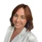 A woman with shoulder-length brown hair, wearing a white blouse, smiling at the camera against a plain white background.