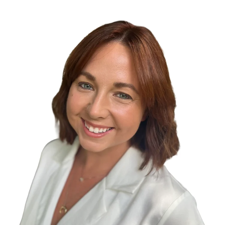 A woman with shoulder-length brown hair, wearing a white blouse, smiling at the camera against a plain white background.