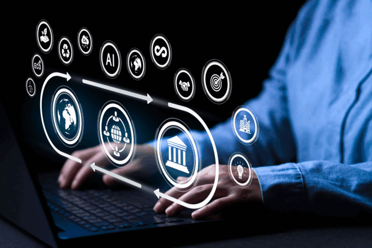 Hands typing on a laptop keyboard with digital icons representing technology, AI, data, and business concepts overlaid above the device.