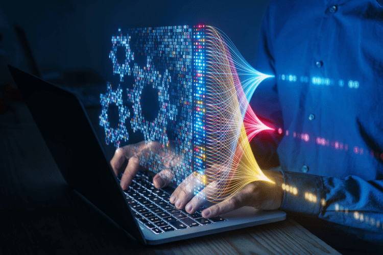 Person typing on a laptop with digital graphics showing gears and data streams, representing concepts of automation, artificial intelligence, and machine learning.